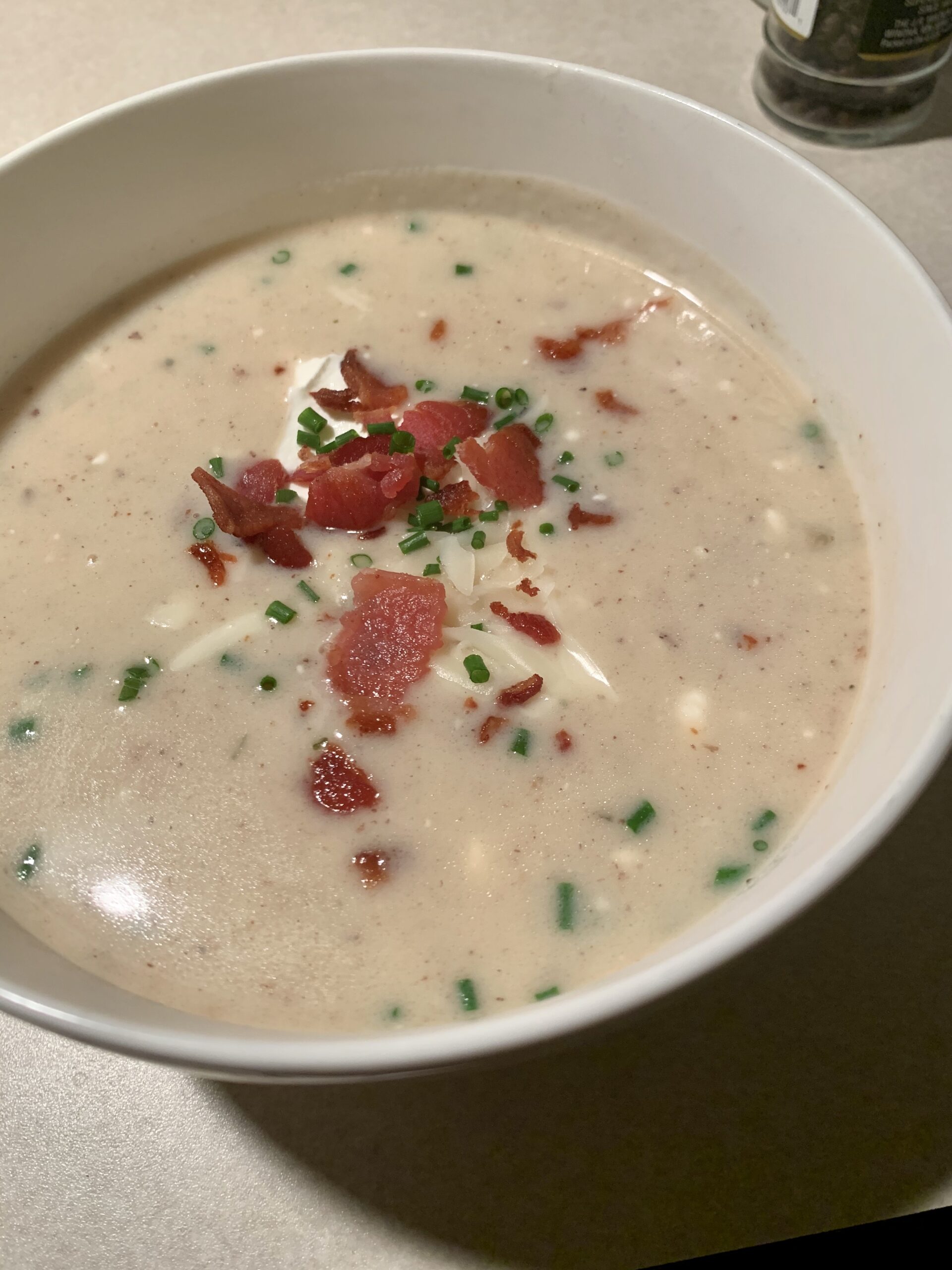 This loaded baked potato soup is topped with sour cream, cheese, and bacon