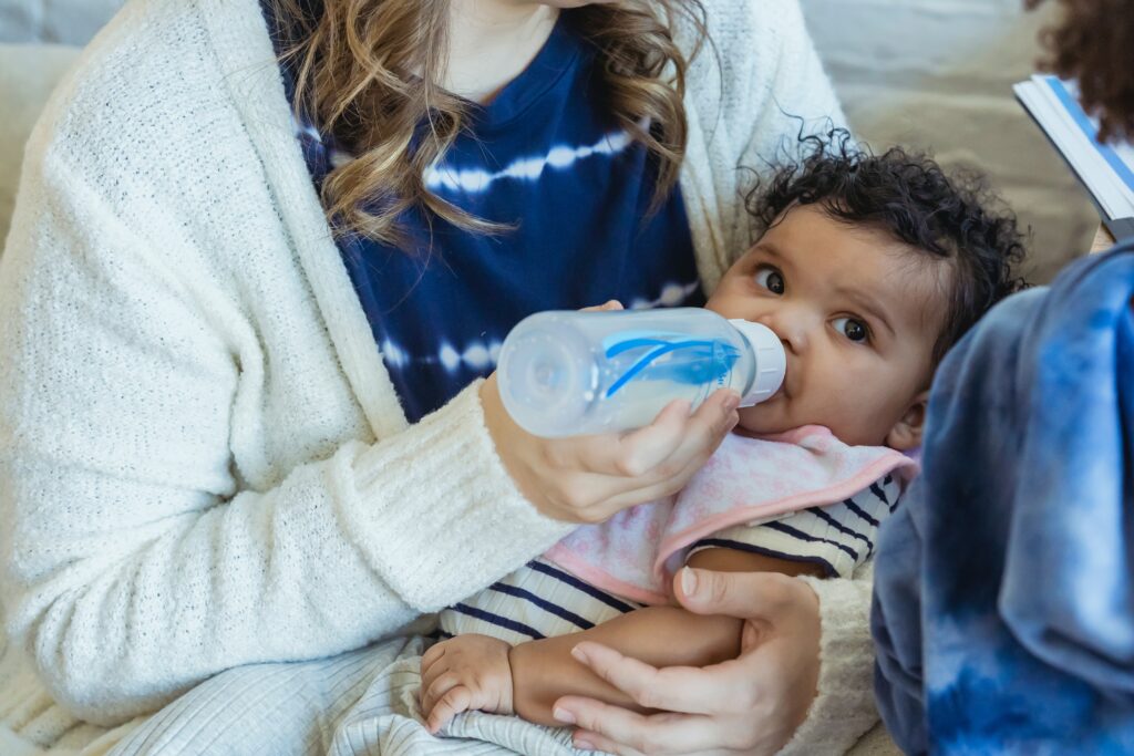 Mother feeding baby with bottle